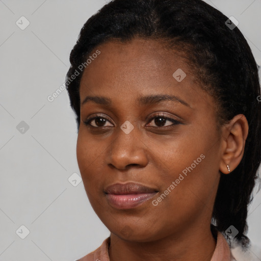 Joyful black young-adult female with short  black hair and brown eyes