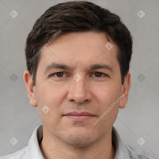 Joyful white adult male with short  brown hair and brown eyes