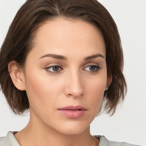 Neutral white young-adult female with medium  brown hair and green eyes