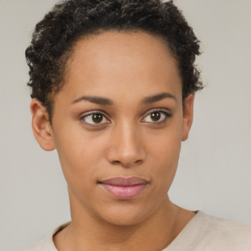 Joyful latino young-adult female with short  brown hair and brown eyes