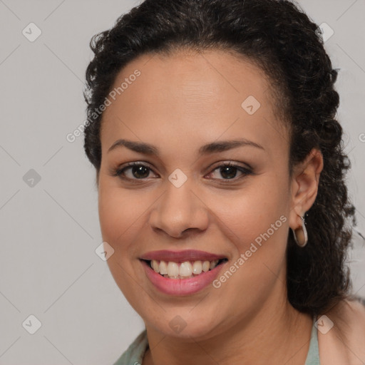 Joyful latino young-adult female with long  brown hair and brown eyes