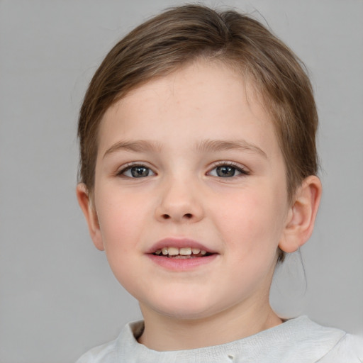 Joyful white child female with short  brown hair and blue eyes