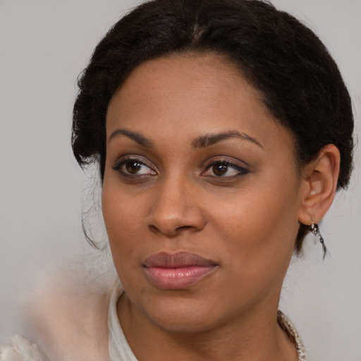 Joyful black young-adult female with medium  brown hair and brown eyes