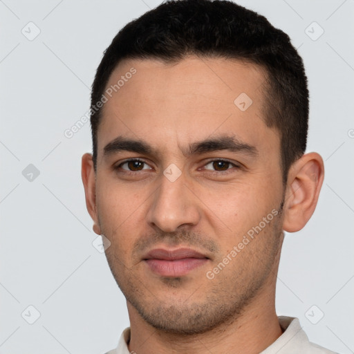 Joyful white young-adult male with short  black hair and brown eyes