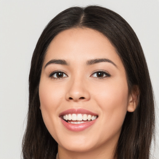 Joyful white young-adult female with long  black hair and brown eyes