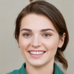 Joyful white young-adult female with medium  brown hair and green eyes