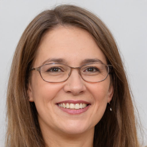 Joyful white adult female with long  brown hair and grey eyes