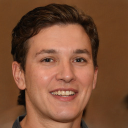 Joyful white adult male with short  brown hair and brown eyes