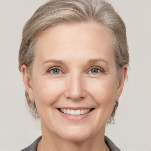 Joyful white adult female with medium  brown hair and grey eyes