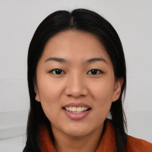 Joyful asian young-adult female with long  black hair and brown eyes