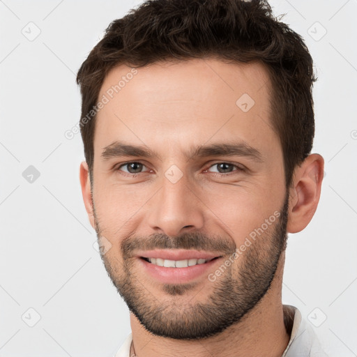 Joyful white young-adult male with short  brown hair and brown eyes