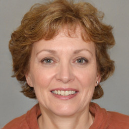 Joyful white adult female with medium  brown hair and blue eyes