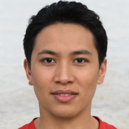 Joyful asian young-adult male with short  black hair and brown eyes