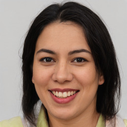 Joyful latino young-adult female with medium  brown hair and brown eyes