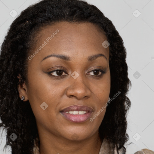 Joyful black young-adult female with long  brown hair and brown eyes