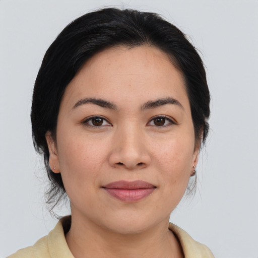 Joyful asian young-adult female with medium  brown hair and brown eyes