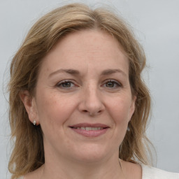 Joyful white adult female with medium  brown hair and blue eyes