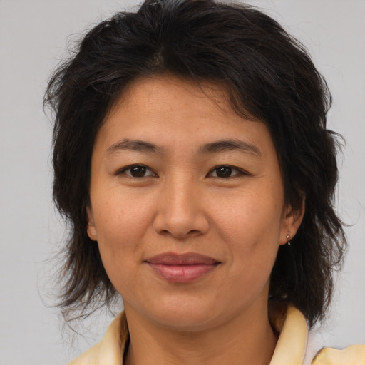 Joyful asian adult female with medium  brown hair and brown eyes