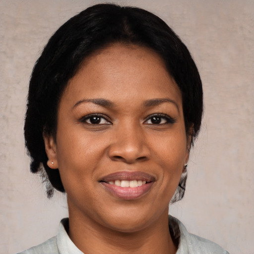 Joyful black young-adult female with medium  black hair and brown eyes