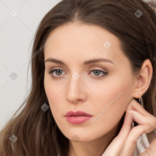 Neutral white young-adult female with long  brown hair and brown eyes