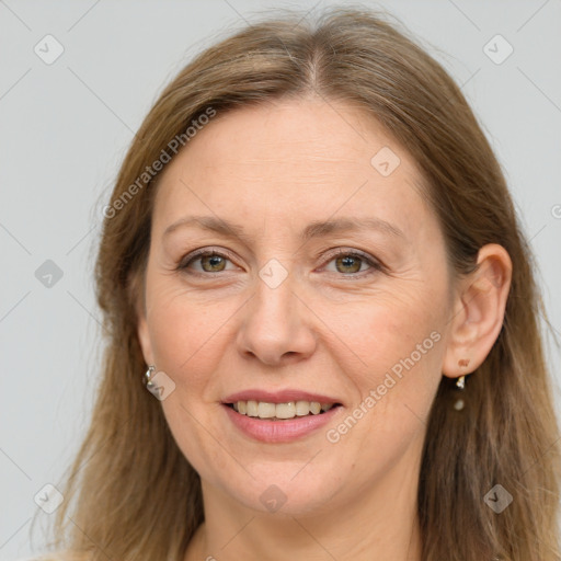 Joyful white adult female with long  brown hair and grey eyes