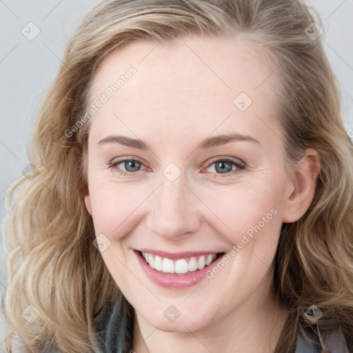 Joyful white young-adult female with long  brown hair and blue eyes