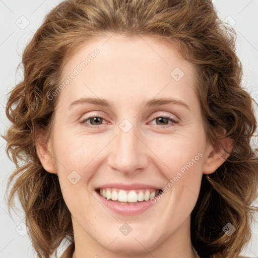 Joyful white young-adult female with medium  brown hair and green eyes