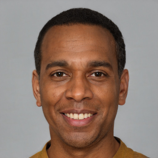 Joyful latino adult male with short  black hair and brown eyes