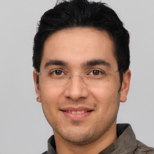 Joyful white adult male with short  black hair and brown eyes