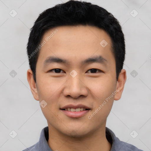 Joyful asian young-adult male with short  black hair and brown eyes