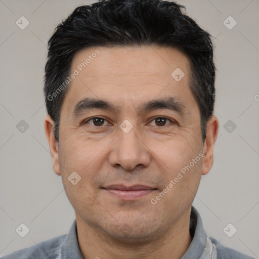 Joyful white adult male with short  black hair and brown eyes