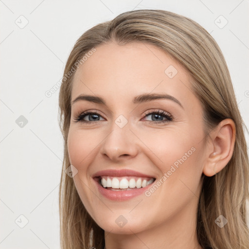 Joyful white young-adult female with long  brown hair and blue eyes