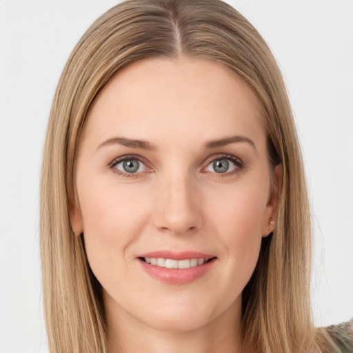 Joyful white young-adult female with long  brown hair and grey eyes