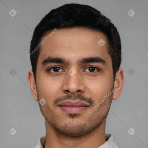 Joyful latino young-adult male with short  black hair and brown eyes