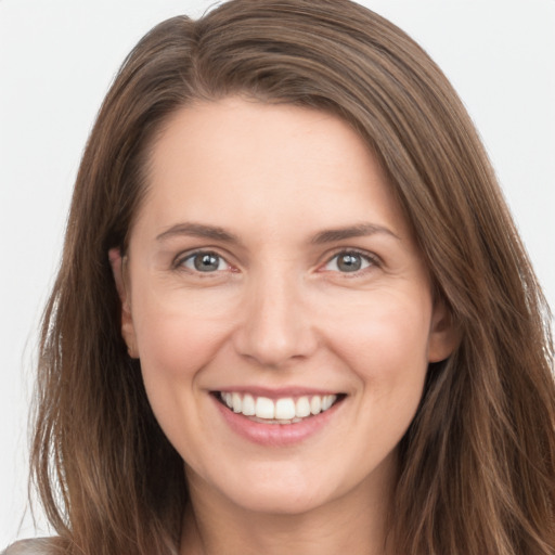 Joyful white young-adult female with long  brown hair and grey eyes