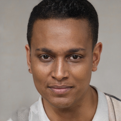 Joyful black young-adult male with short  black hair and brown eyes