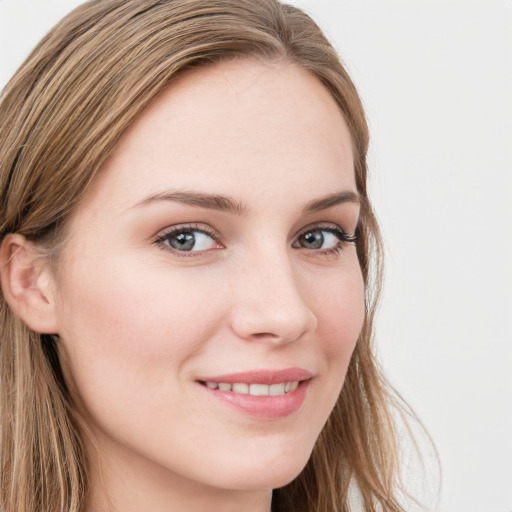 Joyful white young-adult female with long  brown hair and blue eyes