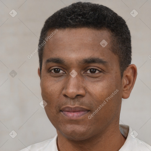 Joyful black young-adult male with short  black hair and brown eyes