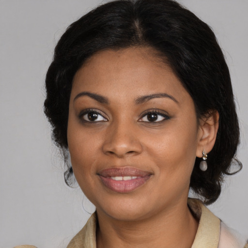 Joyful black young-adult female with medium  brown hair and brown eyes