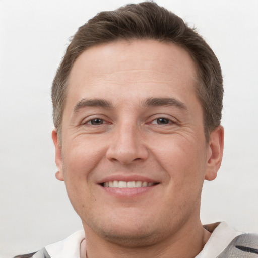 Joyful white young-adult male with short  brown hair and brown eyes