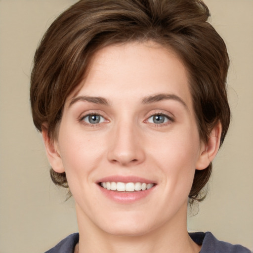 Joyful white young-adult female with medium  brown hair and green eyes