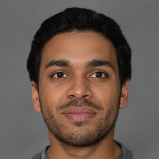 Joyful latino young-adult male with short  brown hair and brown eyes