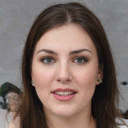 Joyful white young-adult female with long  brown hair and green eyes