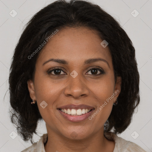 Joyful black adult female with medium  brown hair and brown eyes