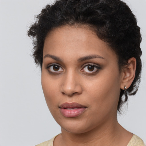 Joyful latino young-adult female with short  brown hair and brown eyes