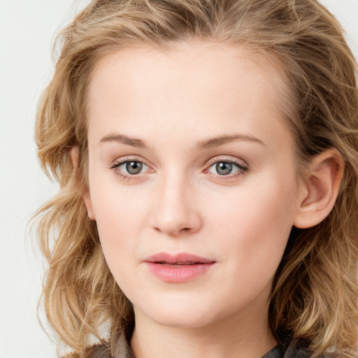 Joyful white young-adult female with long  brown hair and blue eyes