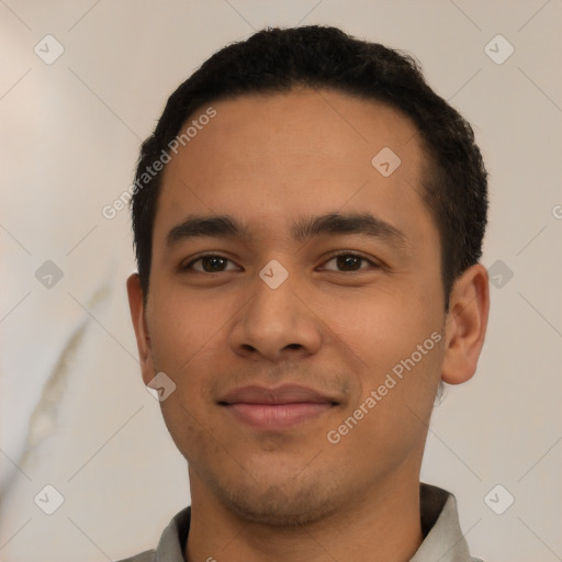 Joyful latino young-adult male with short  black hair and brown eyes