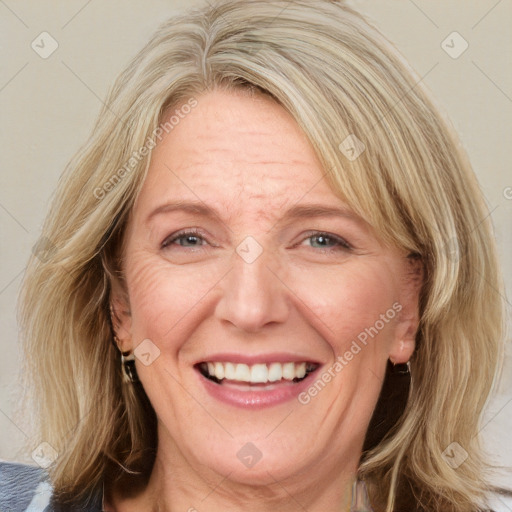 Joyful white adult female with medium  brown hair and blue eyes