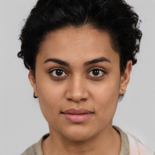 Joyful latino young-adult female with short  brown hair and brown eyes