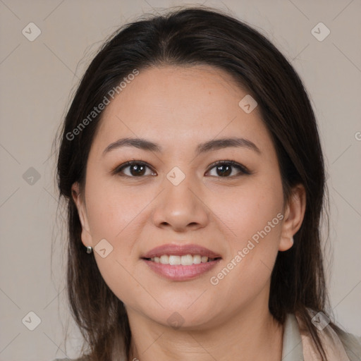 Joyful latino young-adult female with long  brown hair and brown eyes